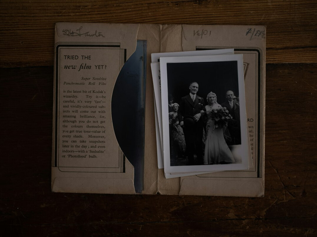 Open folder with documents, photographs and a hand drawn timeline