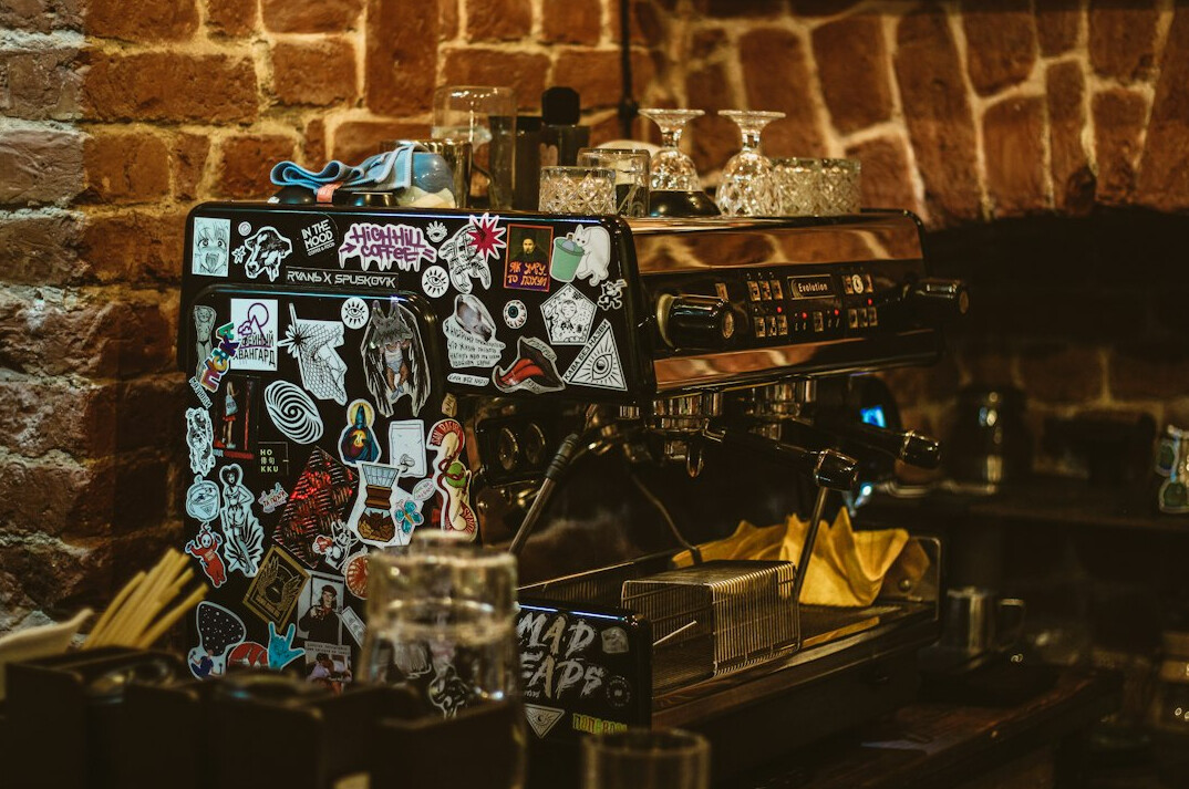 Vintage typewriter with magnifying glass, old photographs and notebook on a desk
