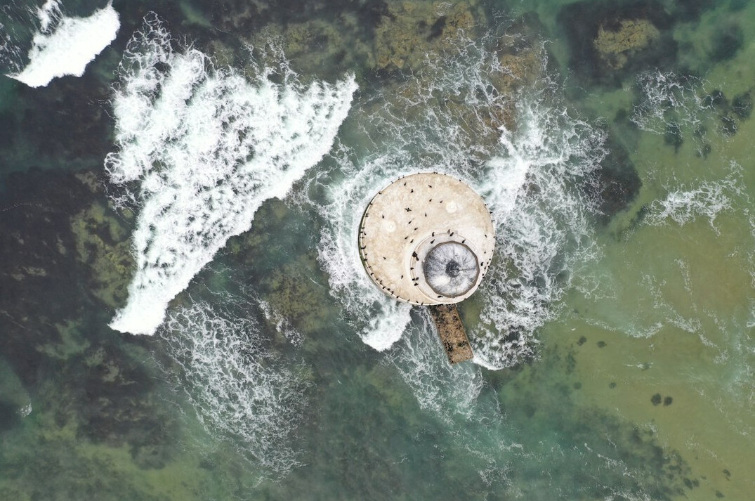 drone flying near lighthouse